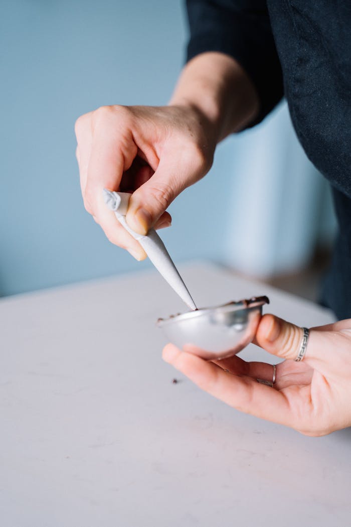 Detailed view of hands skillfully using a piping bag to fill a mold in a kitchen setting.